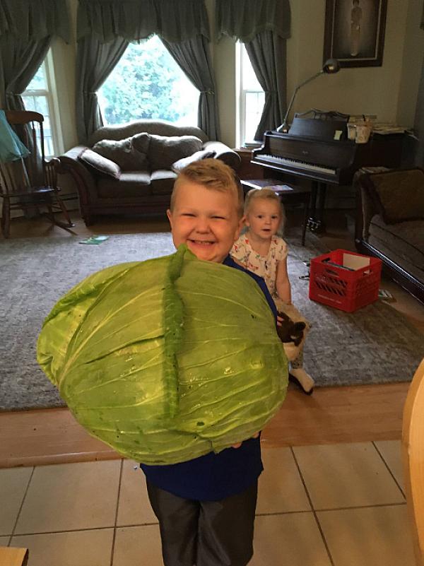 kid with a giant cabbage