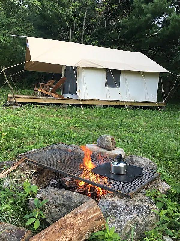 fire ring with kettle and platform tent in background