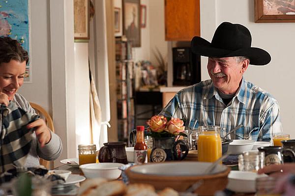 People having breakfast around the kitchen table at the ranch