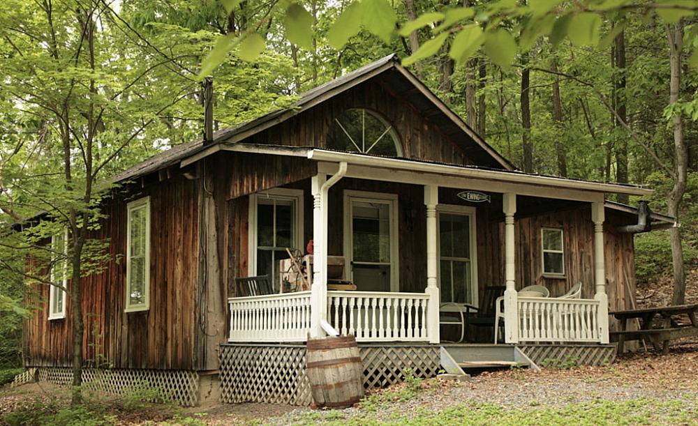 Featured Image- cabin with a white covered front porch