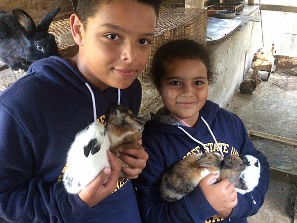 Youth holding rabbits