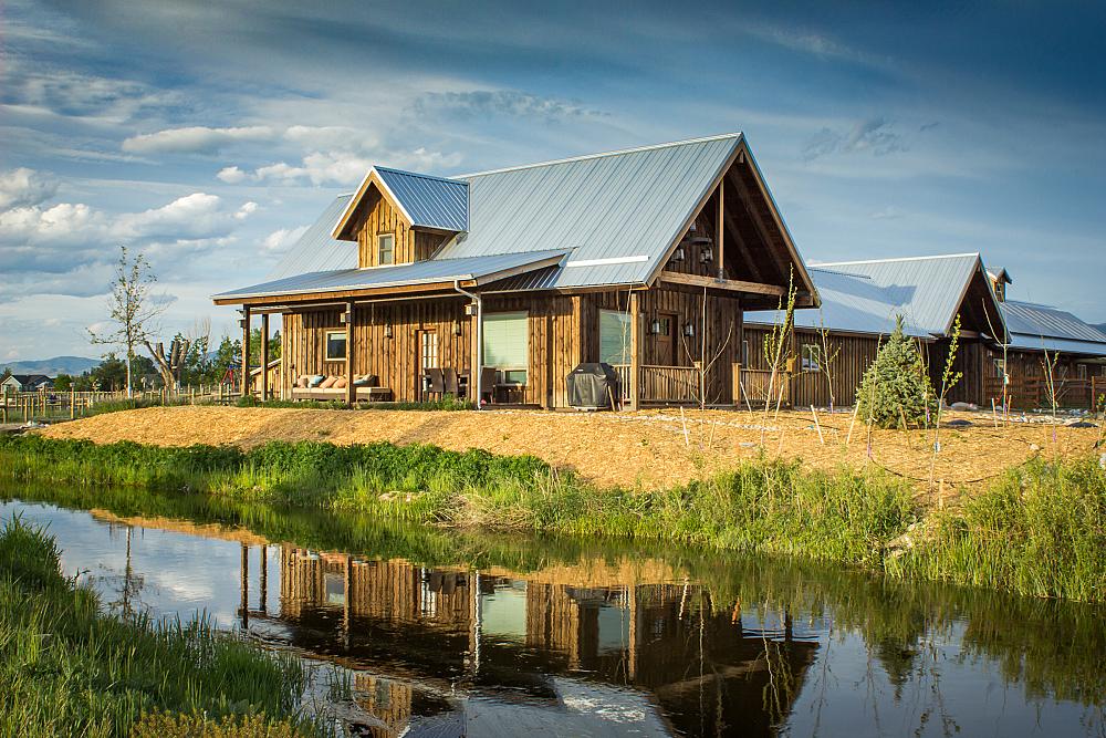 Featured Image - main farmhouse with wood siding and metal roof