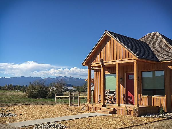wood cabin front porch with red door