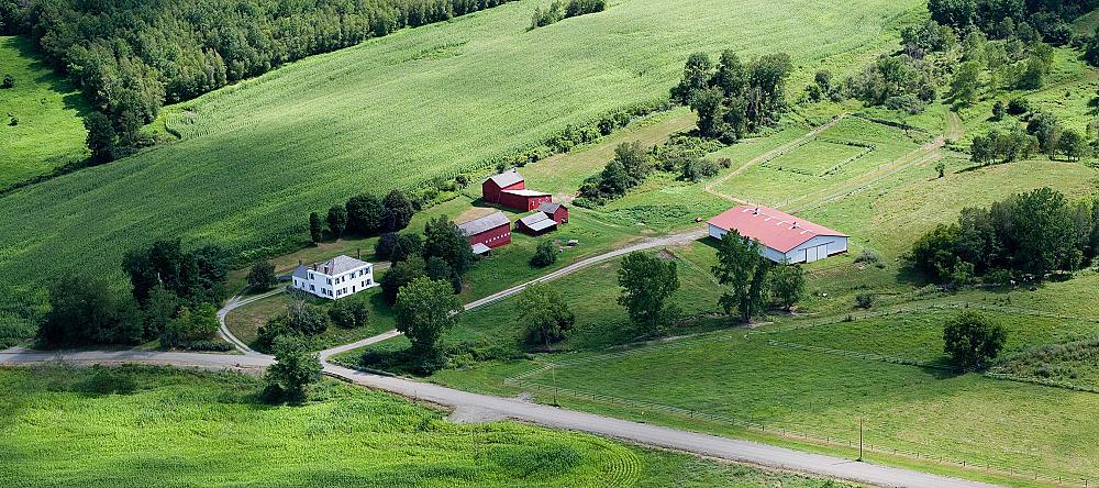 Featured Image - aerial view of a farmstead with farm house, barn and outbuildings