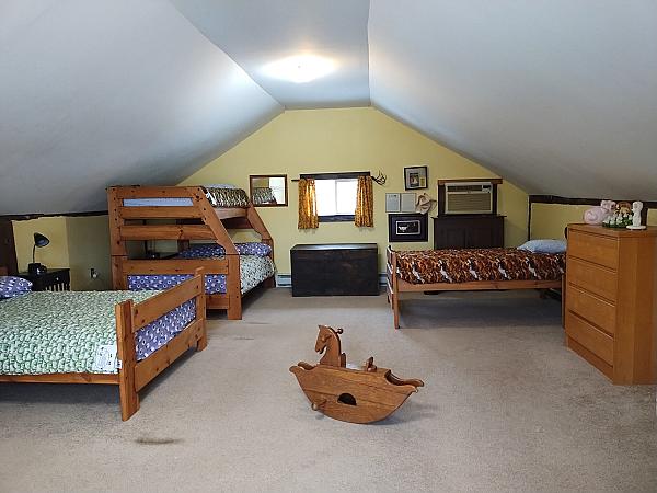 bedroom in loft with three beds