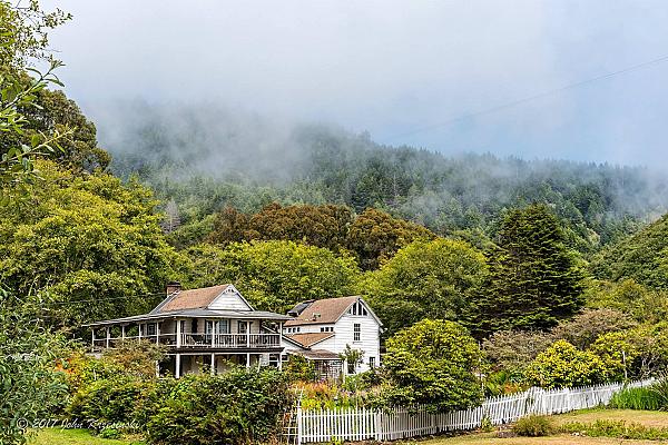 Featured Image - farm house set against a forested hillside