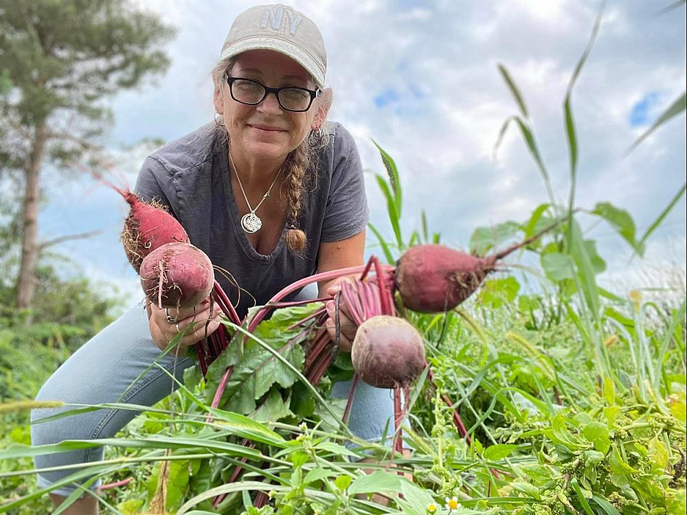 Featured Image-woman holding large beets in field