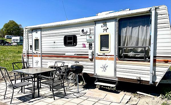 white rv with table out front