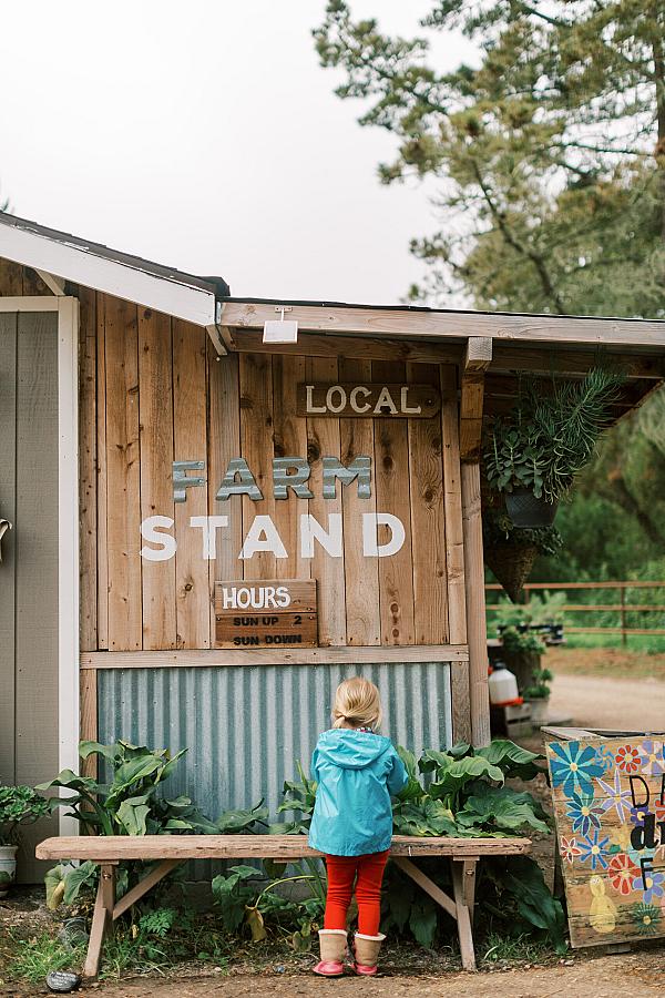 girl in clue coast standing in from of a building