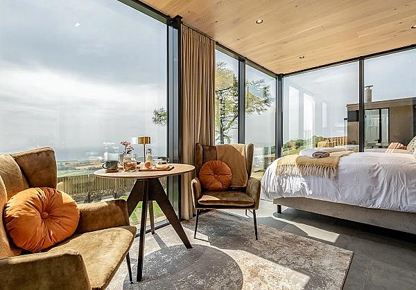 Interior picture of a cabin with a sitting area bed and view 