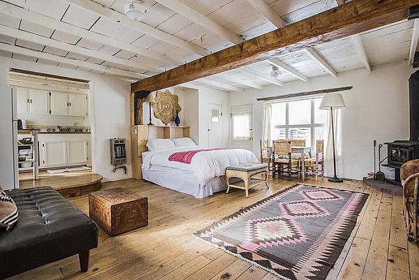 Beautiful bedroom with white walls and hardwood  floors