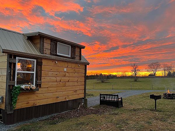 Highland Cottage at Little Tail Farms overlooking the pasture at sunset in Tennessee