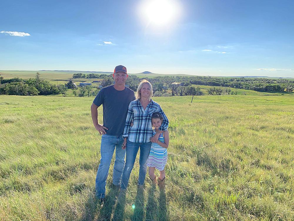 Featured Image - man, woman, and child standing in a field