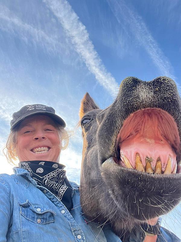 woman and horse laughing