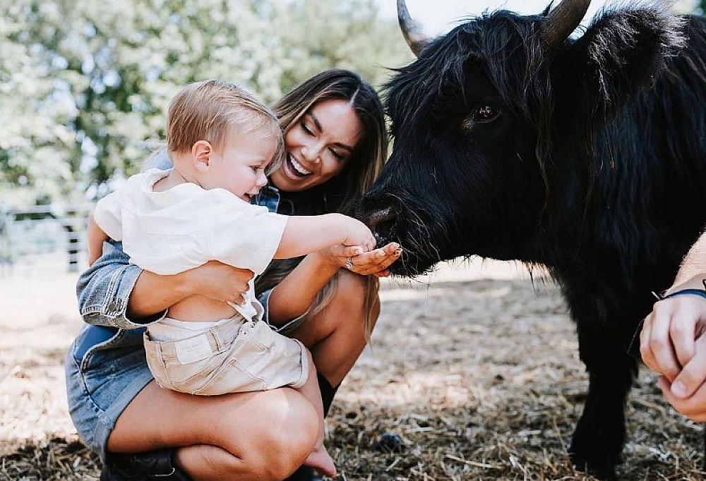 Featured Image- woman and child meeting a cow at True South Farm
