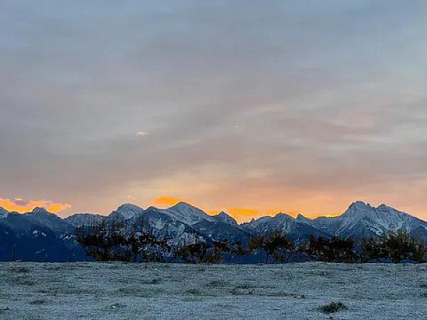 mountains in the distance with sunset behind