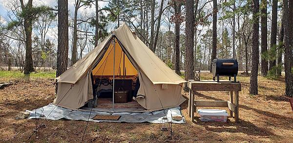 circular tan tent in the woods