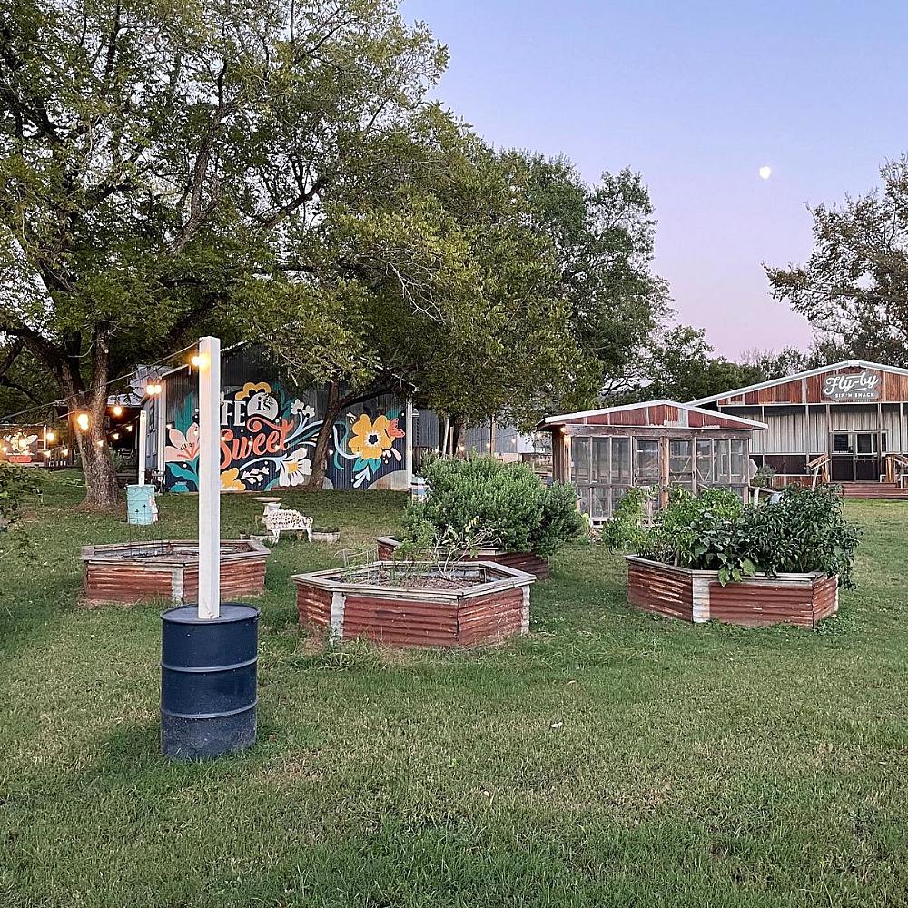 Featured Image - raised beds with greenhouse and barn behind