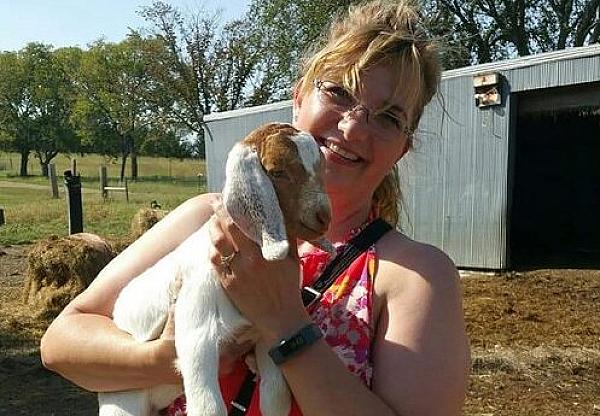 woman holding a goat