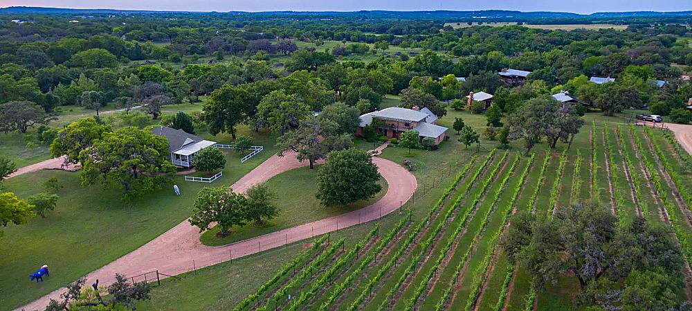 Featured Image - aerial view of farm house and outbuildings