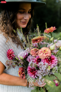 woman with bunch of peonies