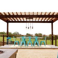 A farmhouse dining table complete with outdoor lights overlooking the main pasture. Enjoy breakfast, a glass of wine or a communal dinner al fresco.