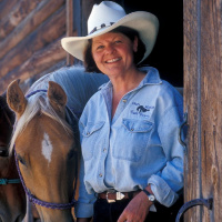 woman in a cowboy hat with horseA