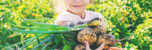 child carrying vegetables