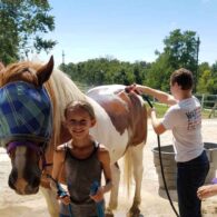 Mulit-species interaction is fun to watch. Kentucky Mountain gelding Domino loves to kiss and play with little Boots goat.