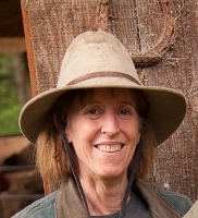 woman in hat smiling at camera