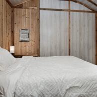 The Omni Cabin bedroom with queen bed, 2 nightstands with charging stations.