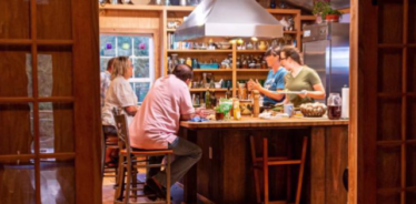 Dogwood Hills hosts with guests in their kitchen